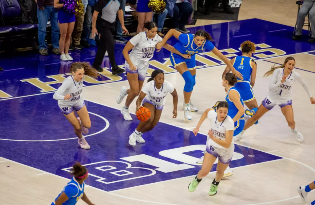 Guard Sayvia Sellers grabs a rebound and starts to run with her teammates against UCLA on December 8, 2024 at Alaska Airlines Arena in Seattle, Wash